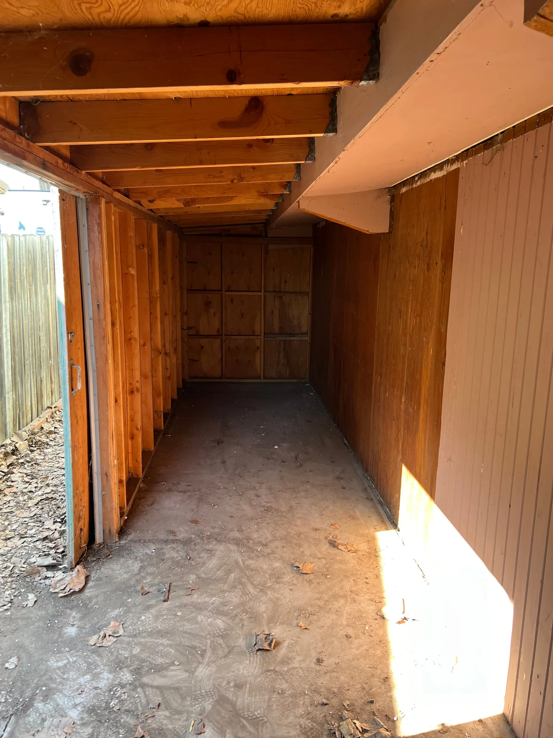 The same garage completely emptied, bare walls and swept floor